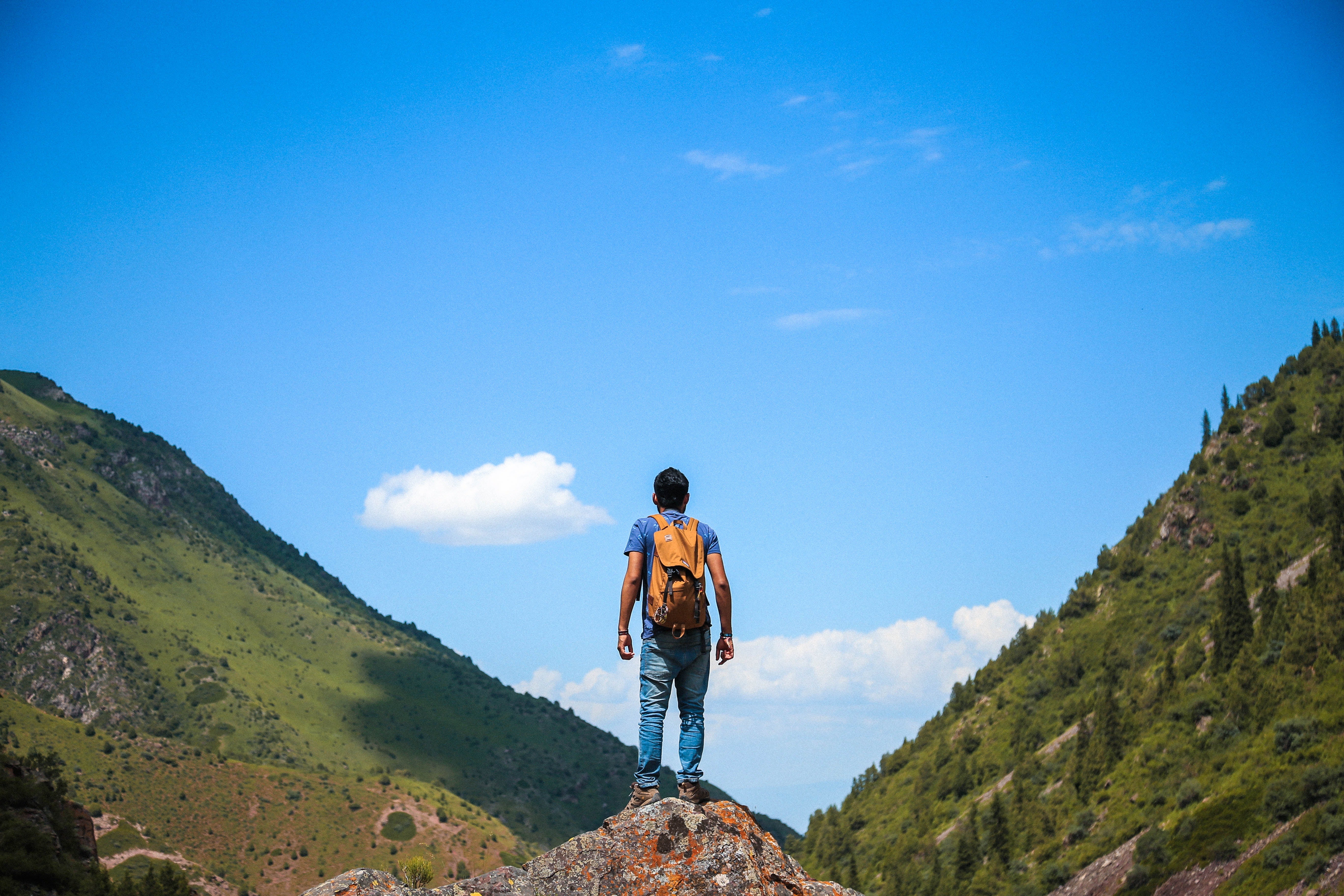 Man in backpack exploring the mountain